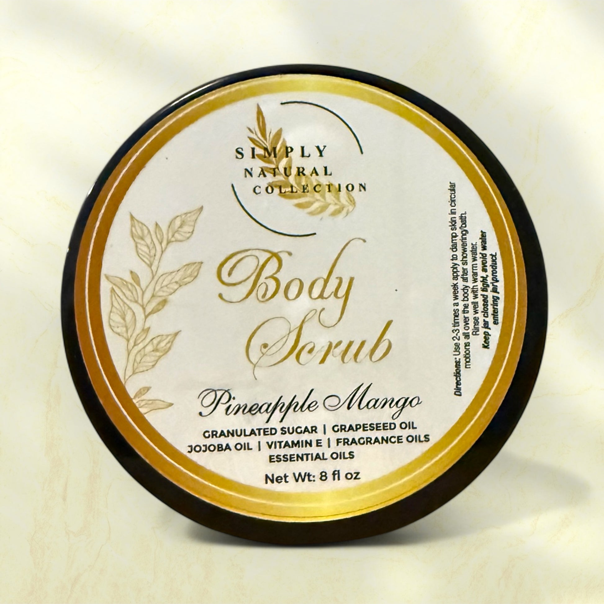 Body scrub container with 'Simply Natural Collection' Pineapple-Mango label on a light background