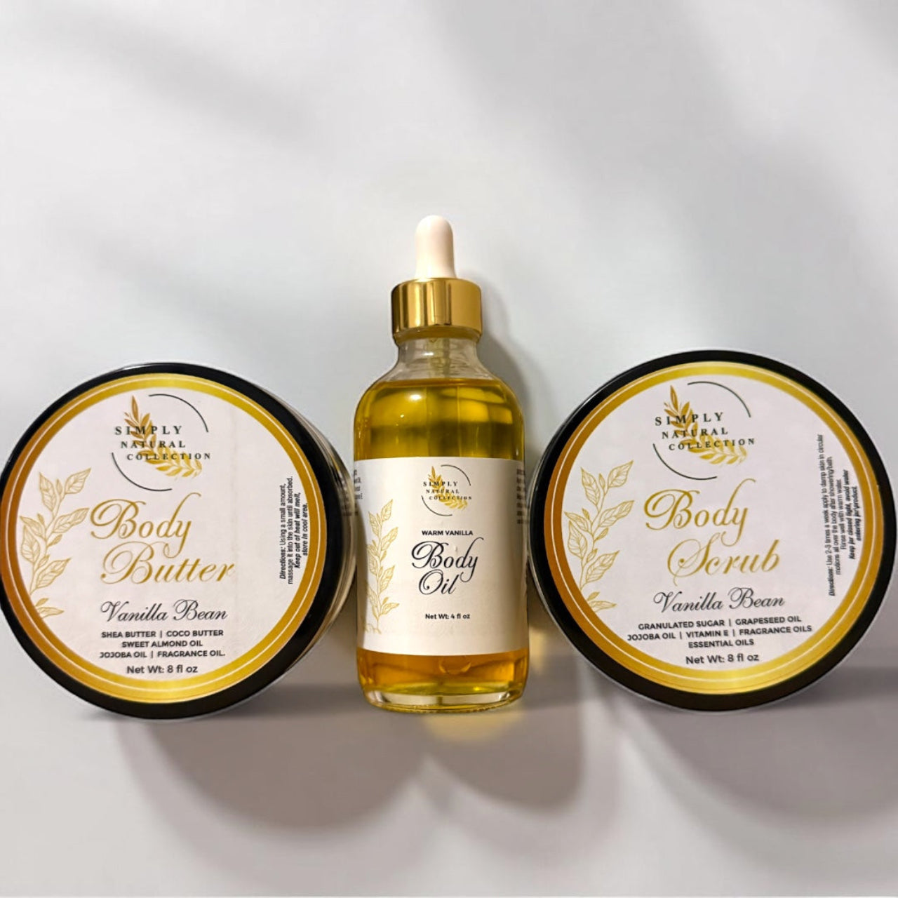 Vanilla Bean body care products including body butter, body oil, and body scrub on a light gray background.