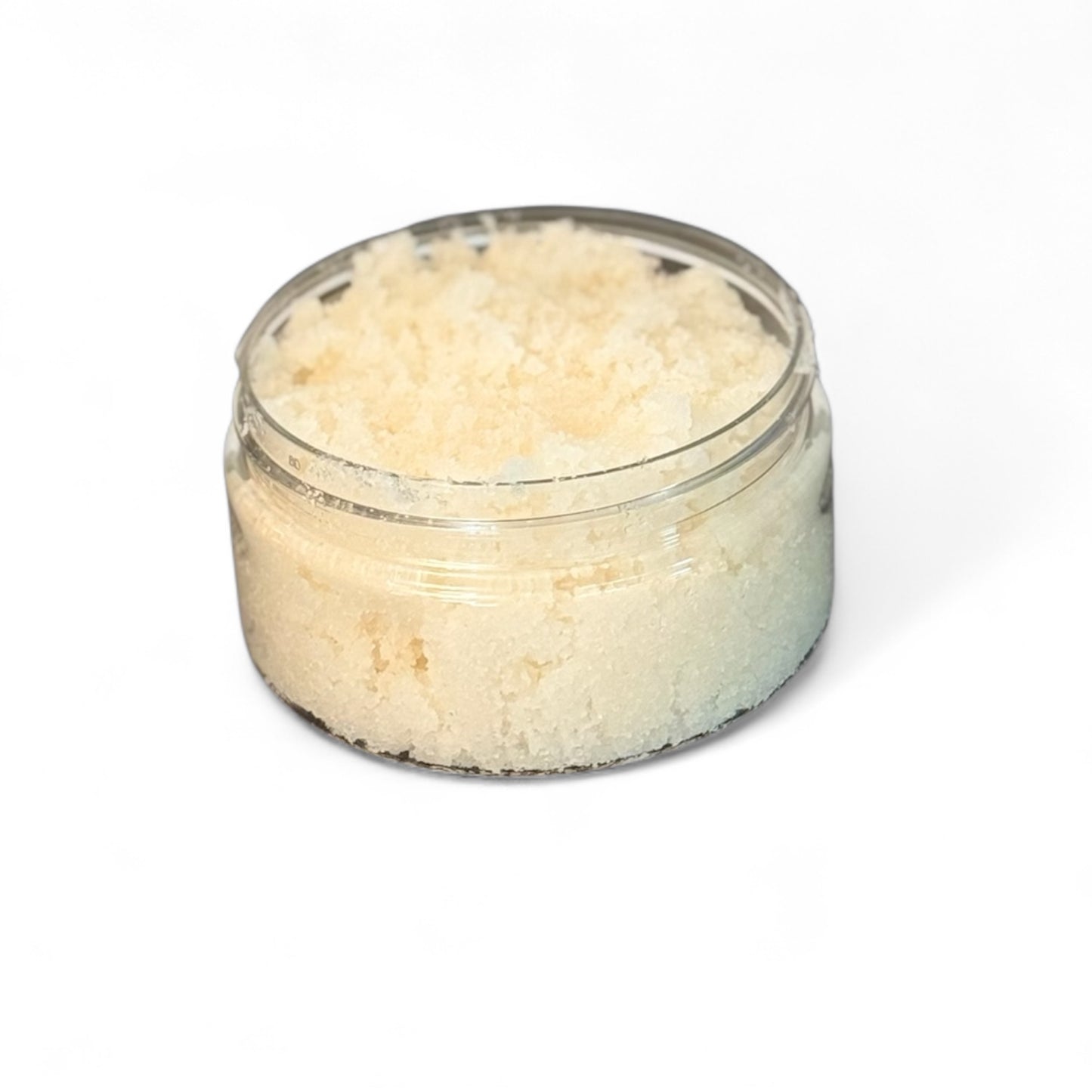 Clear container with Peaches and Cream body scrub on a white background